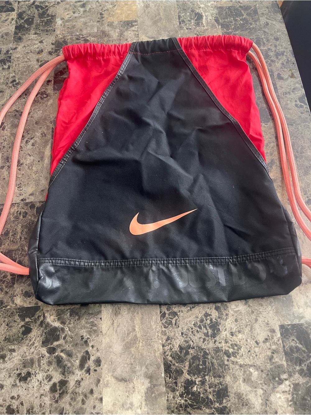 Nike Black and Red Drawstring Backpack with Coral Swoosh